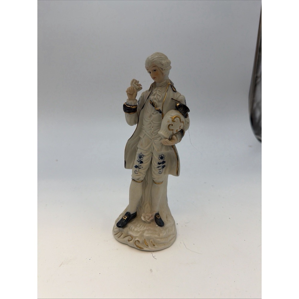 Victorian figurine is crafted from porcelain with blue,‎ white, and gold